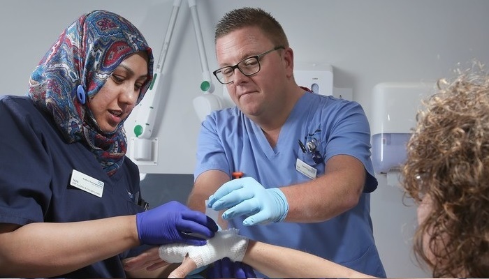Two nursing staff members with a patient