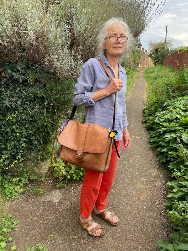 Photo of a woman holding a leather satchel