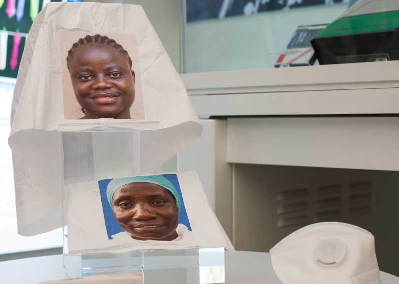 Tyvek PPE suit hoods with staff photographs by artist Mary Beth Heffernan, 2015. Pictured: Marthalyne Freeman RN, Rosaline D. Biago RN. Photo credit: Justine Desmond.