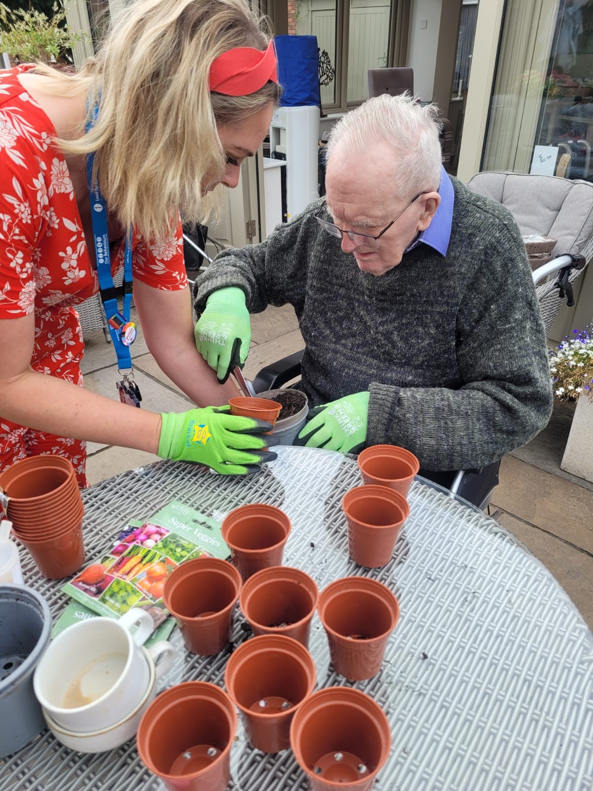 photo of nurse gardening with an older man