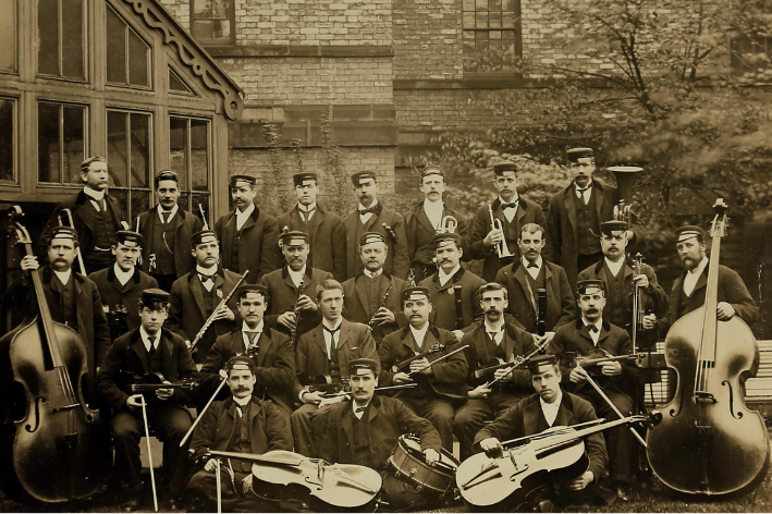 archive photo of a band sat with their instruments