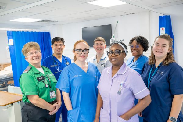 A group of members in the workplace in various uniforms which indicate different roles within nursing