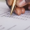 person ticking boxes on a form