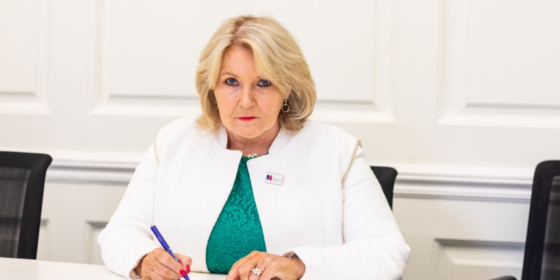 Pat Cullen signing letter in office 