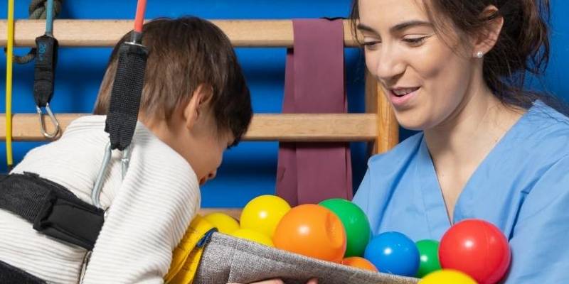 Woman and child playing with toy balls.