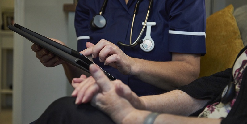 close up of nurse with patient and digital tablet