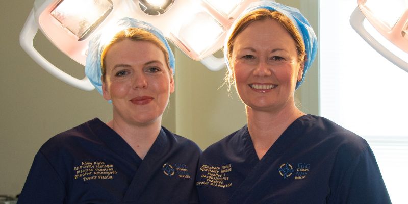 Adele Paris and Elizabeth Thomas in theatre scrubs