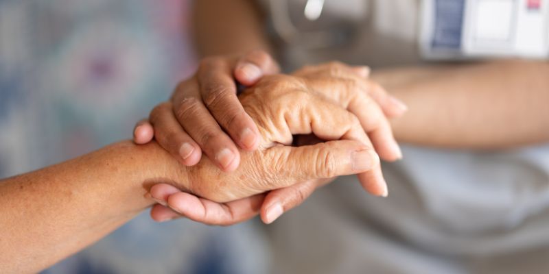 Hands of care staff and resident