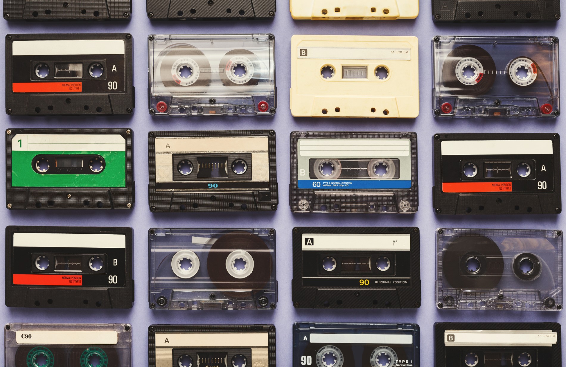 Cassette tapes lined up in grid against purple background
