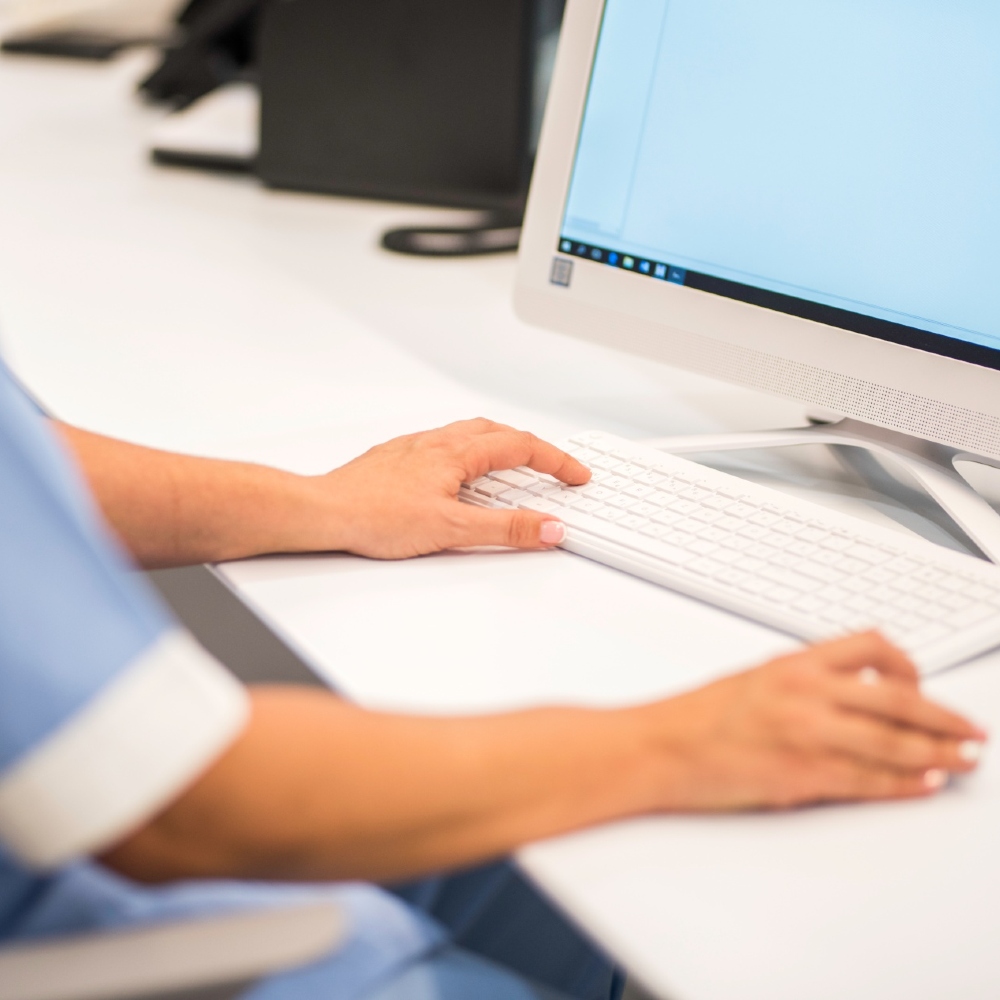 A member of nursing staff uses a computer