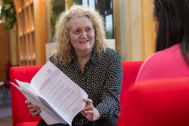 Wendy with menopause passport looking off camera