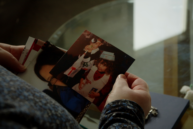 Nurse Nichola looks at photo of self as child in nurse outfit