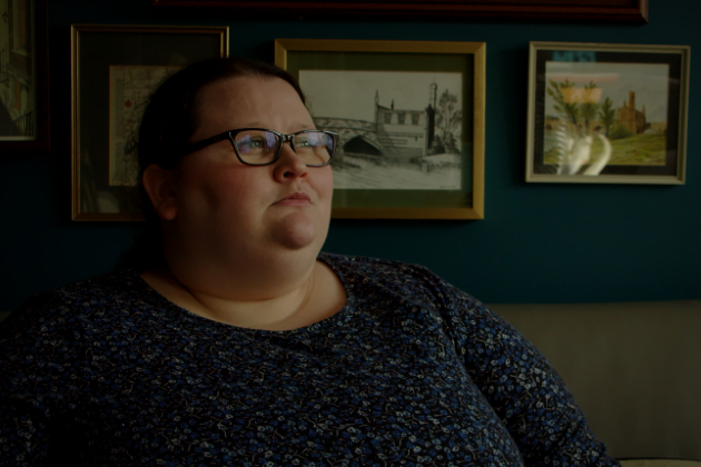 In still from video, nurse Nichola who has long covid looks away from camera