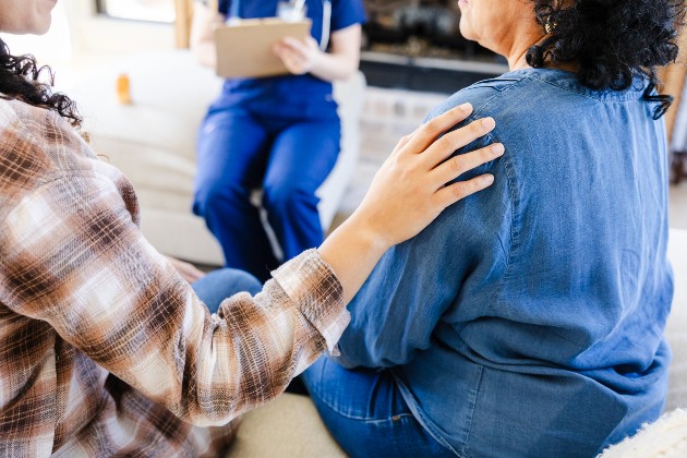 Woman comforts another woman during a health care consultation 