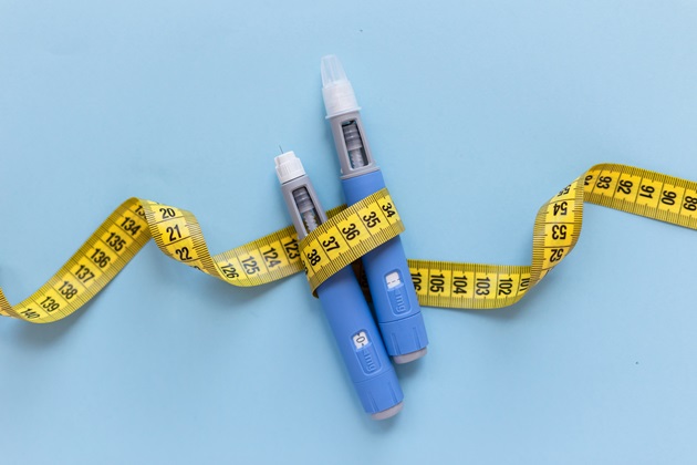weight loss injection with tape measure going around