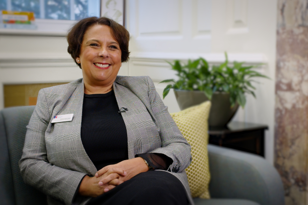 Nicola Ranger sits on a sofa in RCN HQ smiling