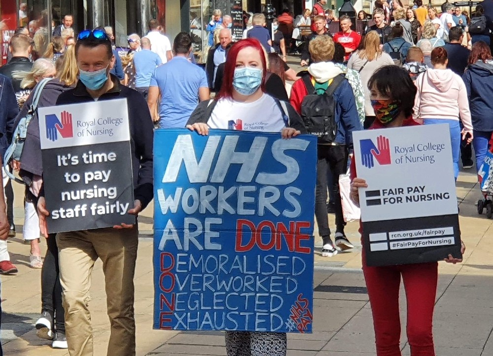 Mel Kerr with NHS pay placard sign