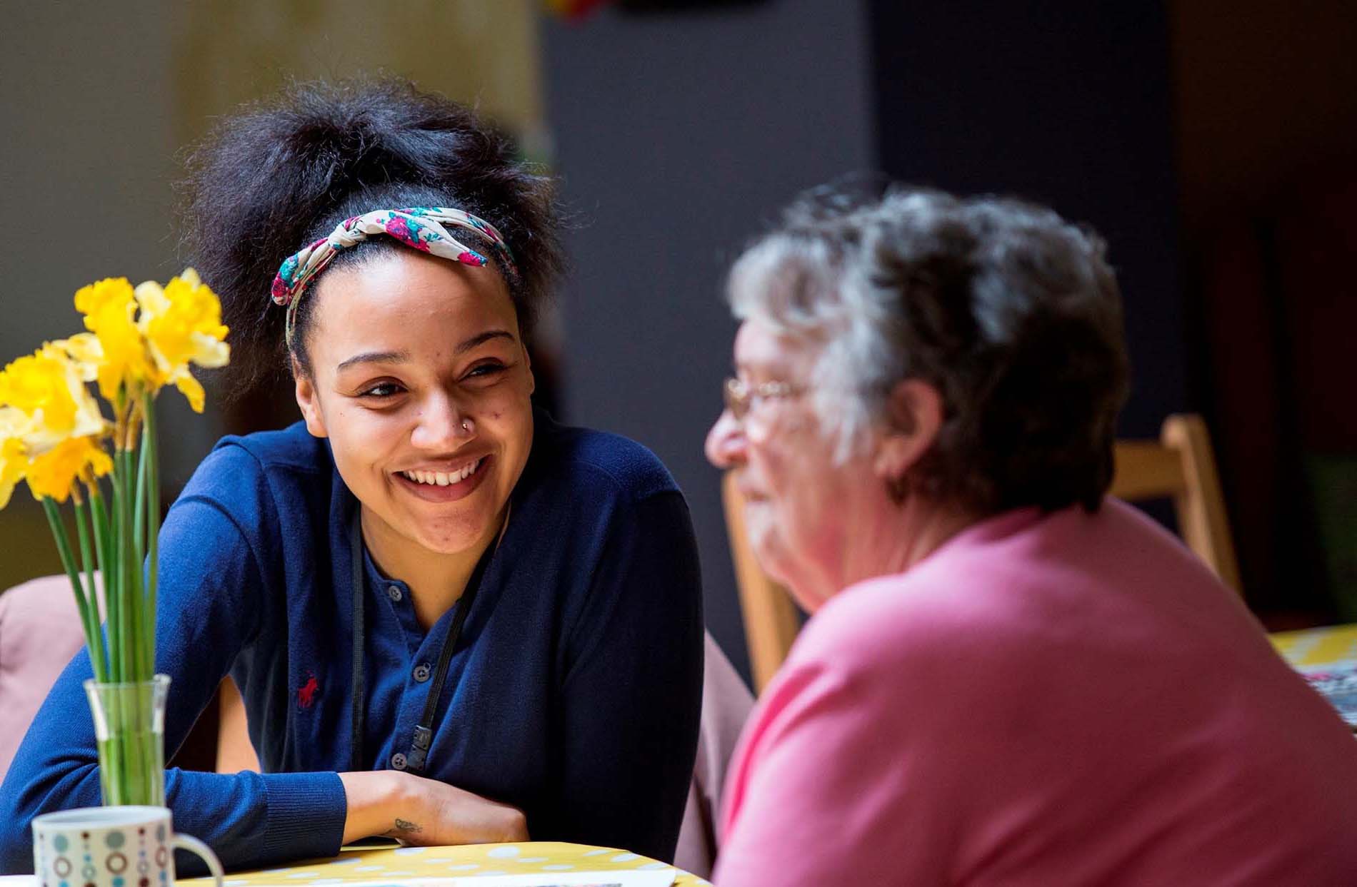 Young woman chats to older woman