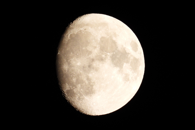 A waxing gibbous moon in the night sky