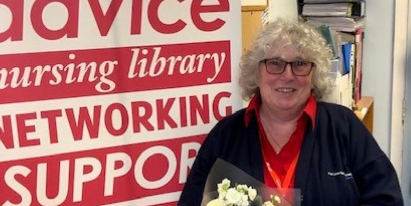 Picture of Win holding flowers and smiling