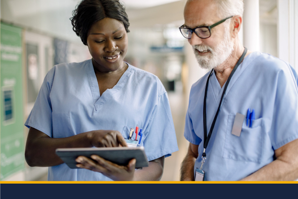 Two nurses looking at a tablet