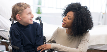 Boy-in-wheelchair-talking-to-nurse