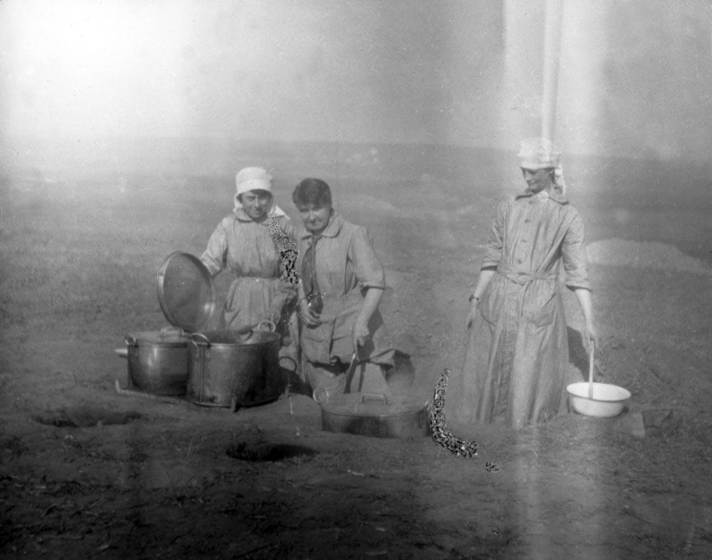 Titled ‘Our Cooks at Medjidia’, Yvonne FitzRoy in centre in Scottish Women’s Hospitals orderly uniform which is different from those of the cooks, Romania.