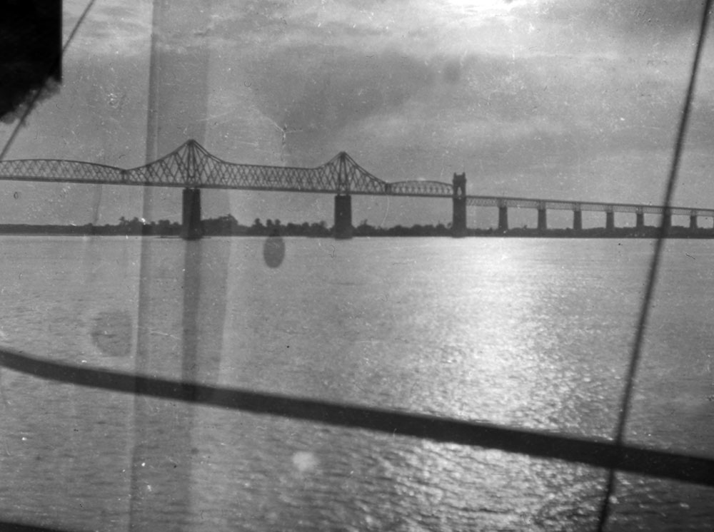 An unknown bridge over a river, photographed from a train window, Romania.