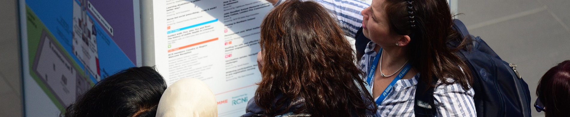 Nurses looking at board at conference